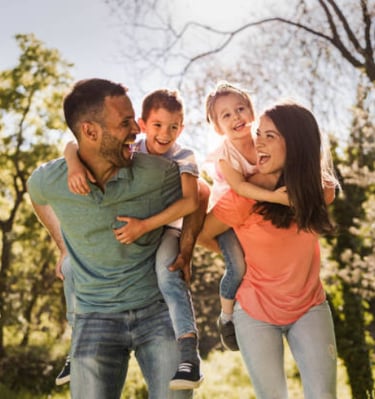 a family of four people are playing with a child