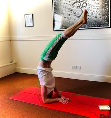a man doing an elbow balance yoga pose