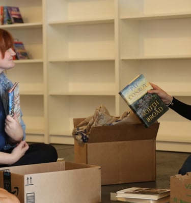 4 people sorting through books at Marigolds Bookstore