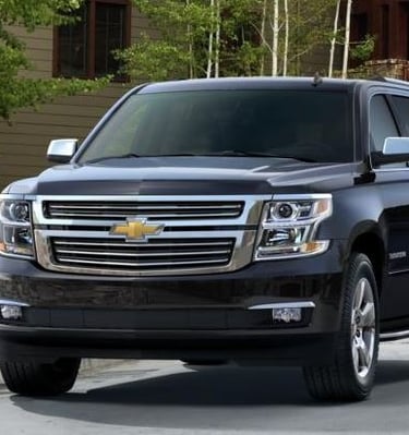 Black Chevy Suburban luxury SUV used for premium transportation services.