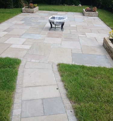 a patio with a fire pit and a fire pit