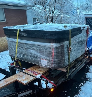 a hot tub on a trailer with lumber