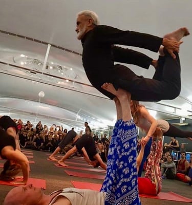 a man in a yoga pose balancing on another mans up stretched legs
