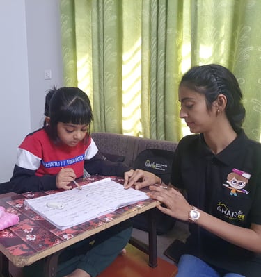 a home tutor from gharpadh sitting on a couch with a child