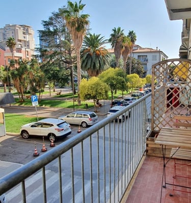 a balcony with a bench and a table with a chair