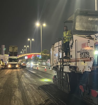 a man standing on a street with a truck behind him