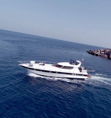 a boat in the water with a lighthouse in the background