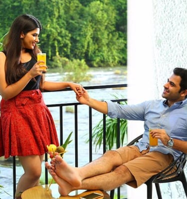 a man and woman holding hands and drinking a drink