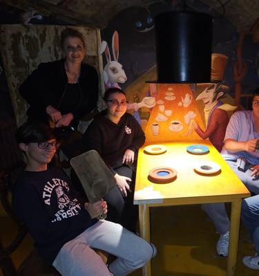 a group of people sitting around a table with a table with a table cloth
