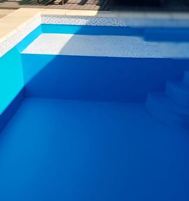 a pool with a blue pool and a pink ball