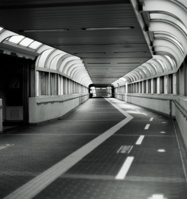 a long hallway with a long walkway and a long hallway