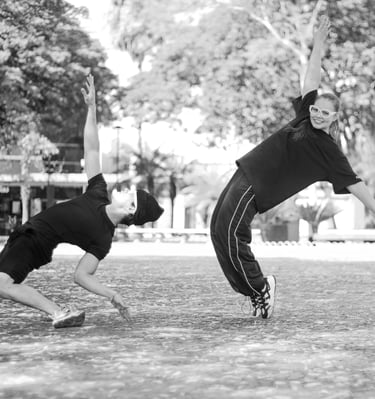 a man and a woman playing baseball in a park