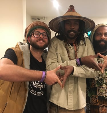 three men standing next to each other in a room