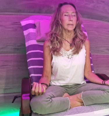 Client relaxing inside the Harmonic Egg for bio-energy and sound frequency therapy.