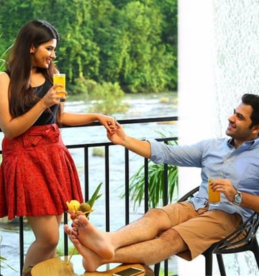 a man and woman holding hands and drinking a drink