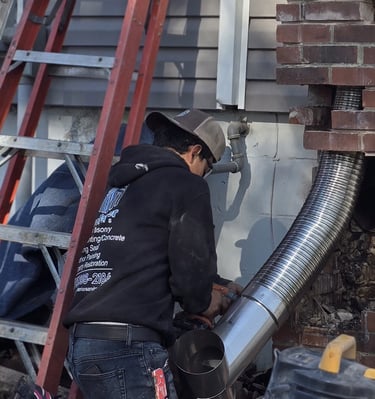 "Profaster installing a steel flue liner in a chimney in Des Moines, IA."