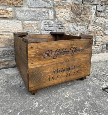 a wooden planter with personalised engraving on the front