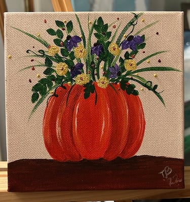 Yellow and Purple Flowers in a Pumpkin