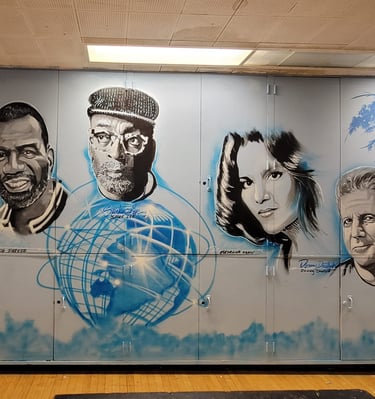 A mural inside of a classroom celebrating people associated with the school.