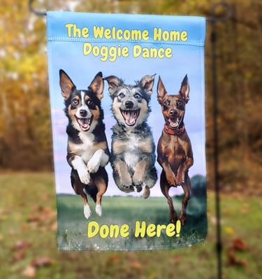 A garden flag picturing three happy dogs jumping and "the welcome home happy dance done here!".