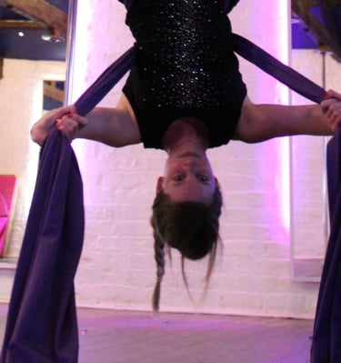 Image of student at Sxefit aerial silks class upside down