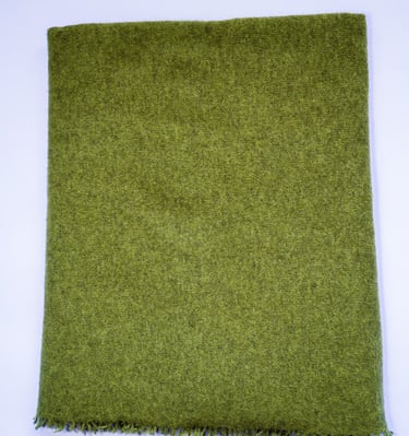 Luxurious dark green yak wolle scarf with soft texture and fringed edges, neatly folded on white.