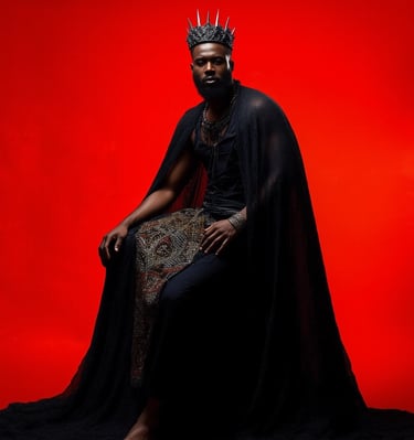 a black man with a crown and capelet dress
