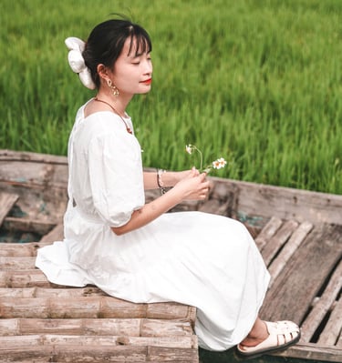 a photo of a young vietnamese woman in a rice field