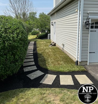 excellent landscaping and hardscaping of grass, stones and trees by NP Landscaping
