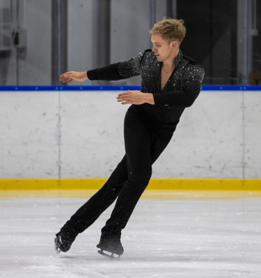 Adult figure skater performing element 3