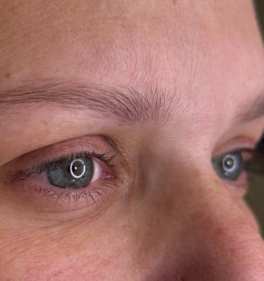 A woman with her current state of eyebrows before getting microblading procedure