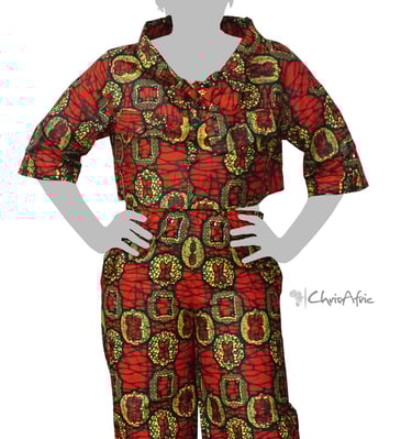 a woman in a red and green patterned blouse and pants
