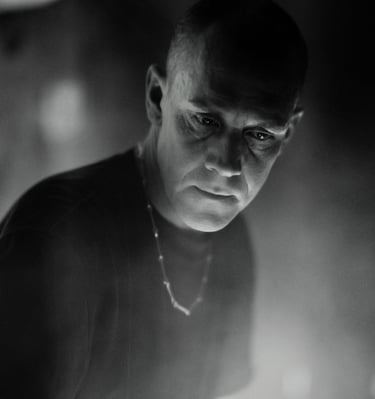 a man in a black shirt and a clock