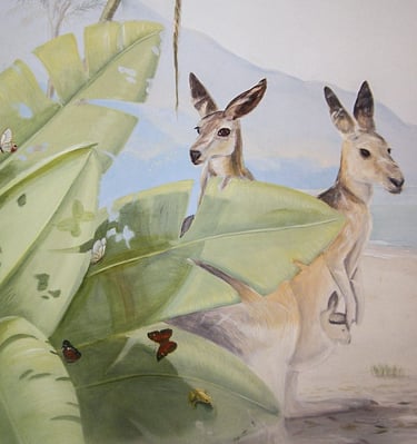 Kids' mural of two life size kangaroos peeking out behind lush tropical leaves on a beach.