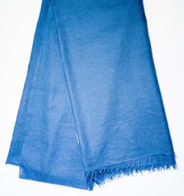 Elegant pure pashmina shawl in deep blue with soft fringes, perfect for timeless luxury style.