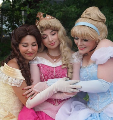 Belle, Cinderella, and Aurora share a hug