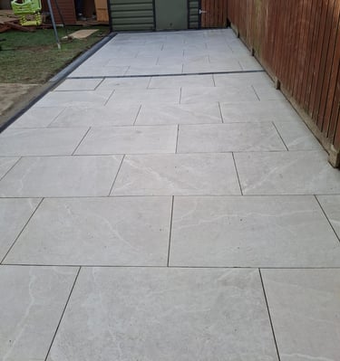 a patio with a concrete patio with a wooden fence