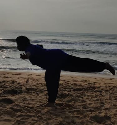 a person doing yoga on a beach