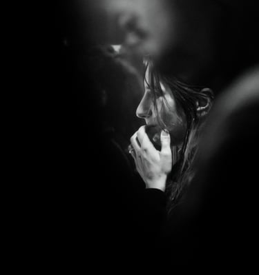 a woman talking on her cell phone while she is holding a cell phone