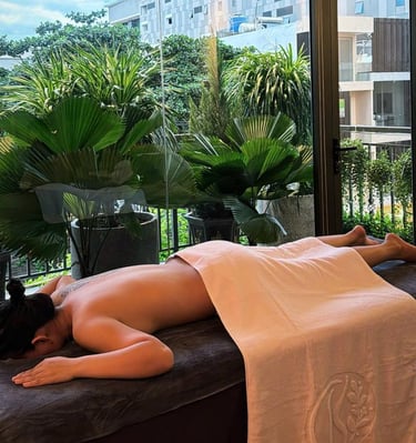 a woman is laying on a bed in a room with a view of a balcony