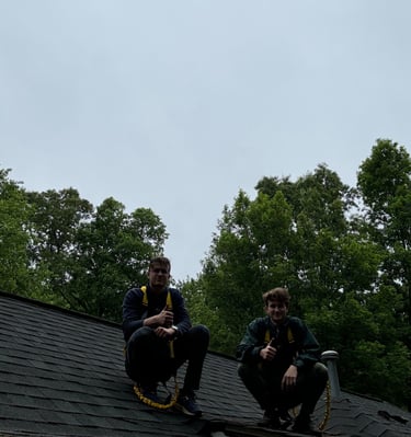 2 owners of studs gutters sitting on roof