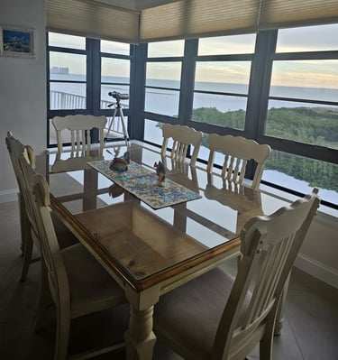 a dining room table with chairs and a table