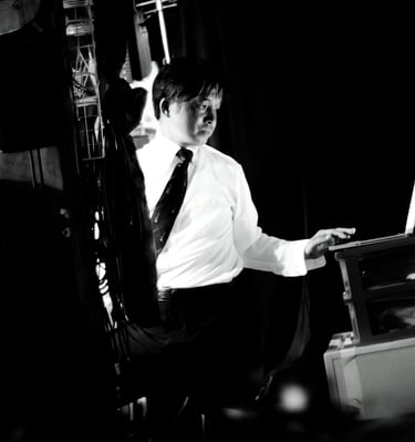 a man in a suit and tie is sitting at a desk