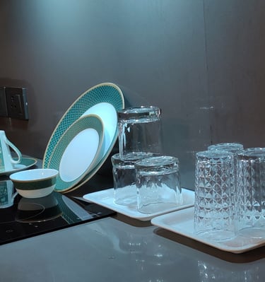 a kitchen counter top with a plate and glasses