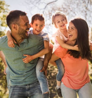a family of four people are playing with a child