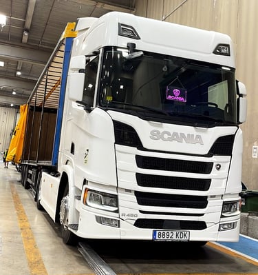 a truck with a trailer parked in a warehouse