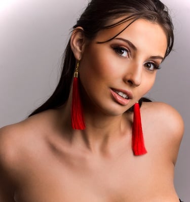 a beautiful woman with a red tassel earrings