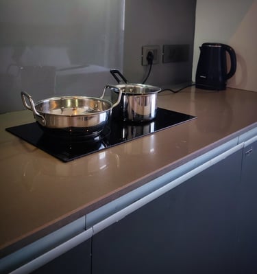 a stove top with pots and pans on a counter