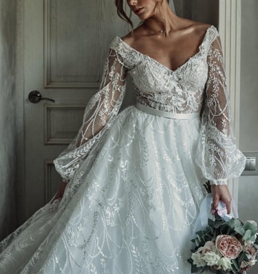 a woman in a wedding dress with a bouquet in her hand