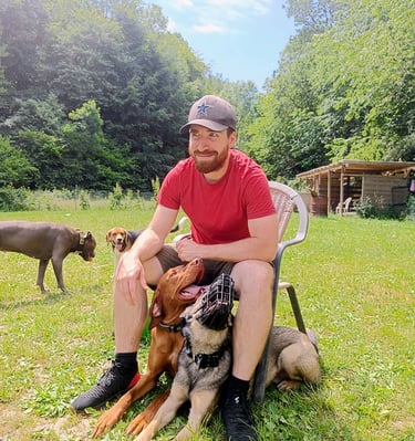 Hundetrainer mit Hund auf dem Schoß, entspannte Atmosphäre in der Hundeschule